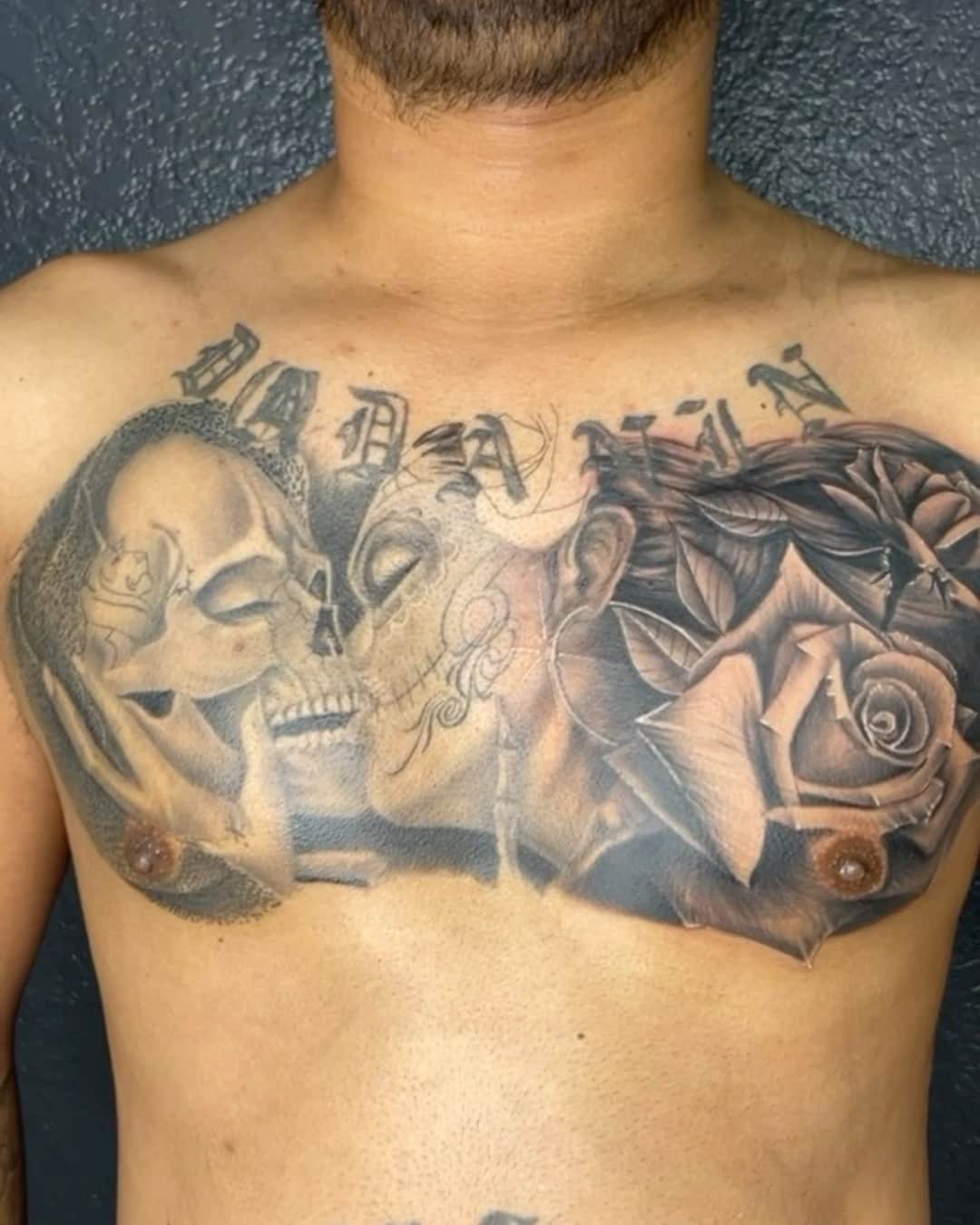 Skull, rose and lettering tattoo on the chest, large piece, Chicano style, by Inksane Shorty in Austin, TX