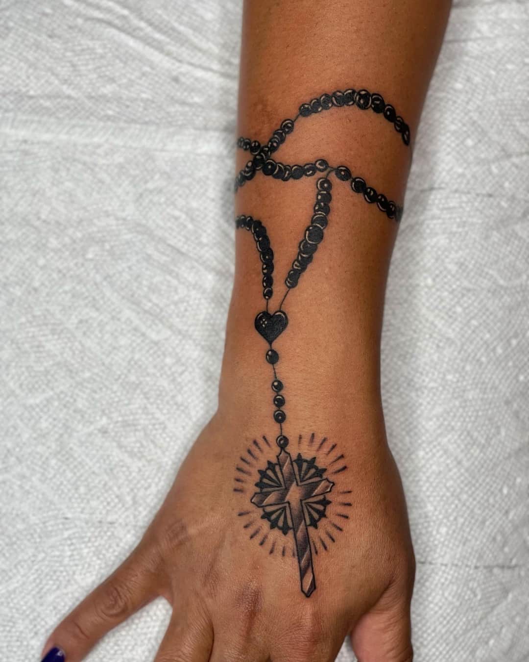 Cross, rosary, heart symbol and temporary tattoo on the hand, Chicano style, by Inksane Shorty in Austin, TX