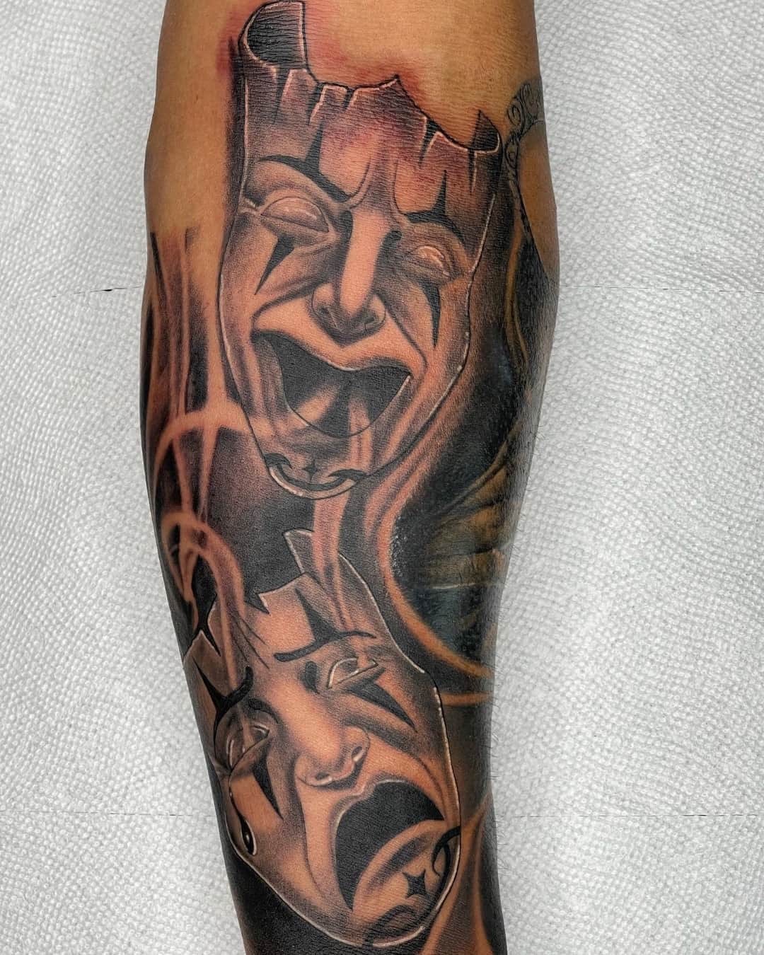 Theater mask and comedy tragedy masks tattoo on the forearm, Chicano style, by Inksane Shorty in Austin, TX