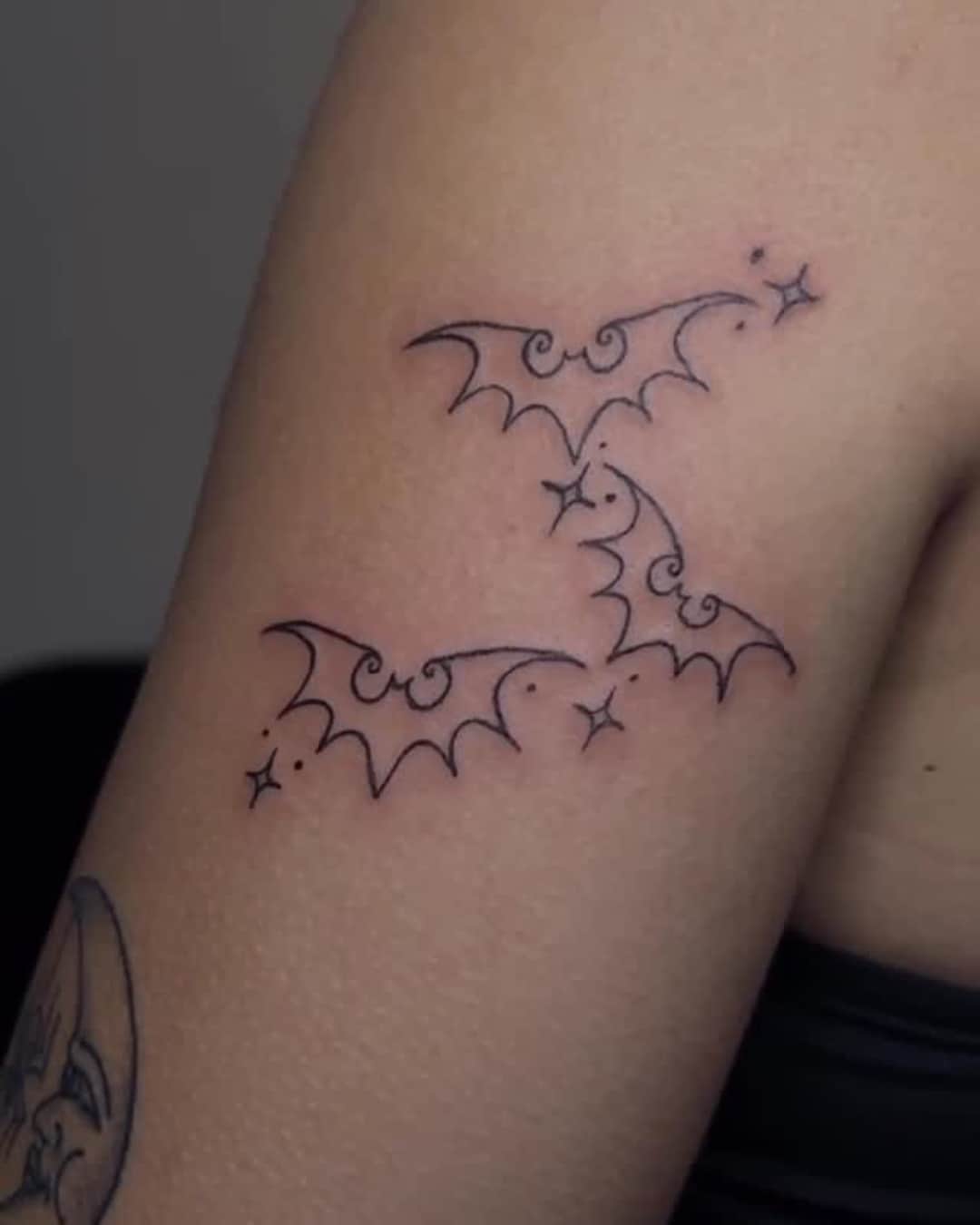 Bat and star tattoo on the upper arm, Cyber-tribal style, by Emma in Austin, TX