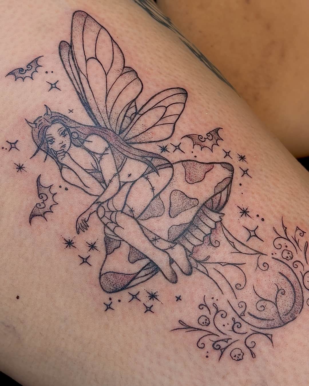 Mushroom, fairy, star and bat tattoo on the thigh, Fine Line style, by Emma in Austin, TX