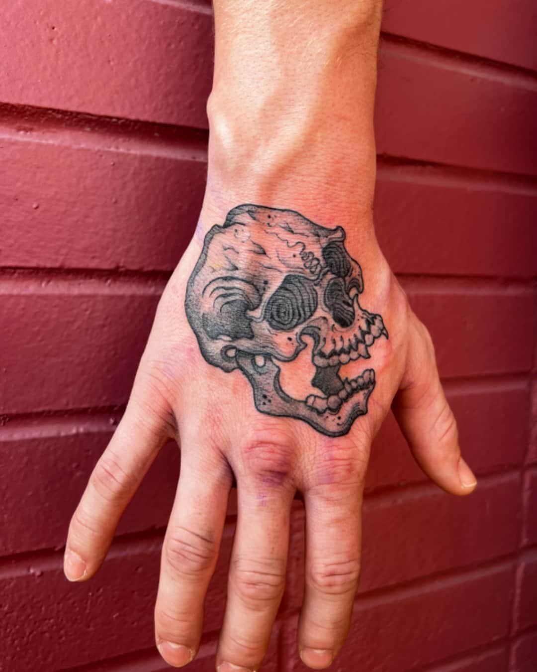 Small skull tattoo on the hand, Illustrative style, by Donny Newman in Austin, TX