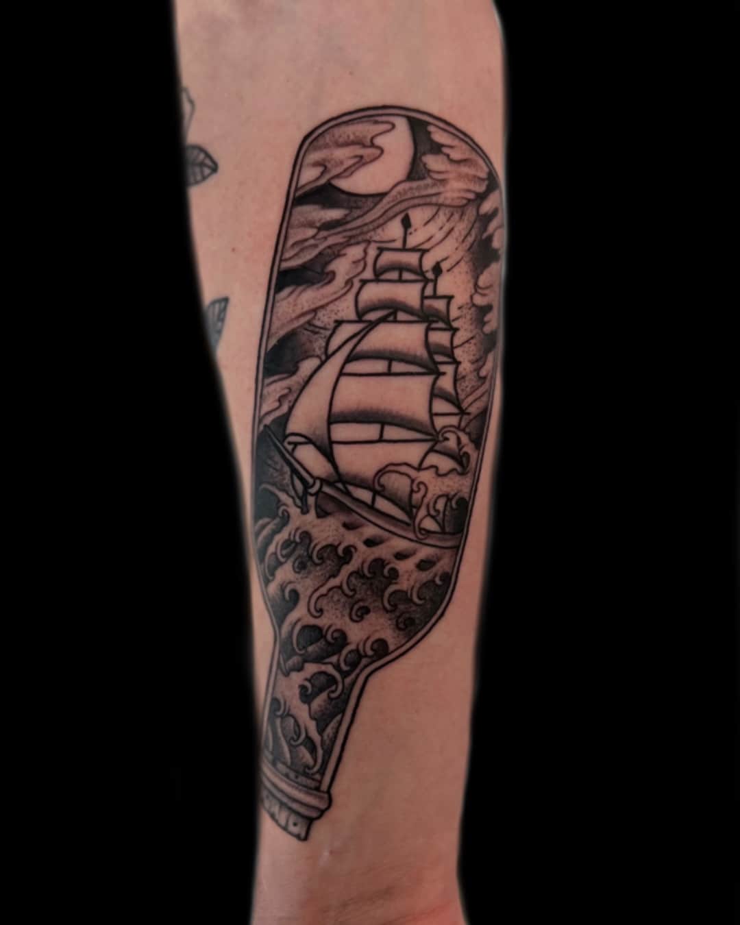Small ship, bottle and wave tattoo on the forearm, Illustrative style, by Donny Newman in Austin, TX