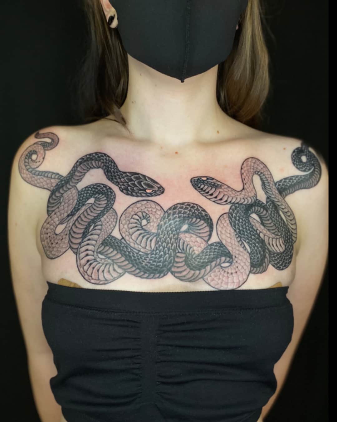 Snake tattoo on the chest, large piece, Illustrative style, by Donny Newman in Austin, TX