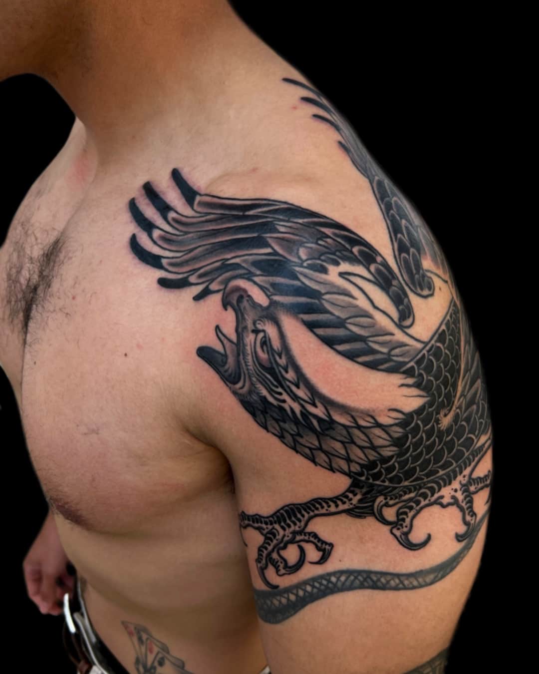 Dragon tattoo on the shoulder, large piece, Illustrative style, by Donny Newman in Austin, TX