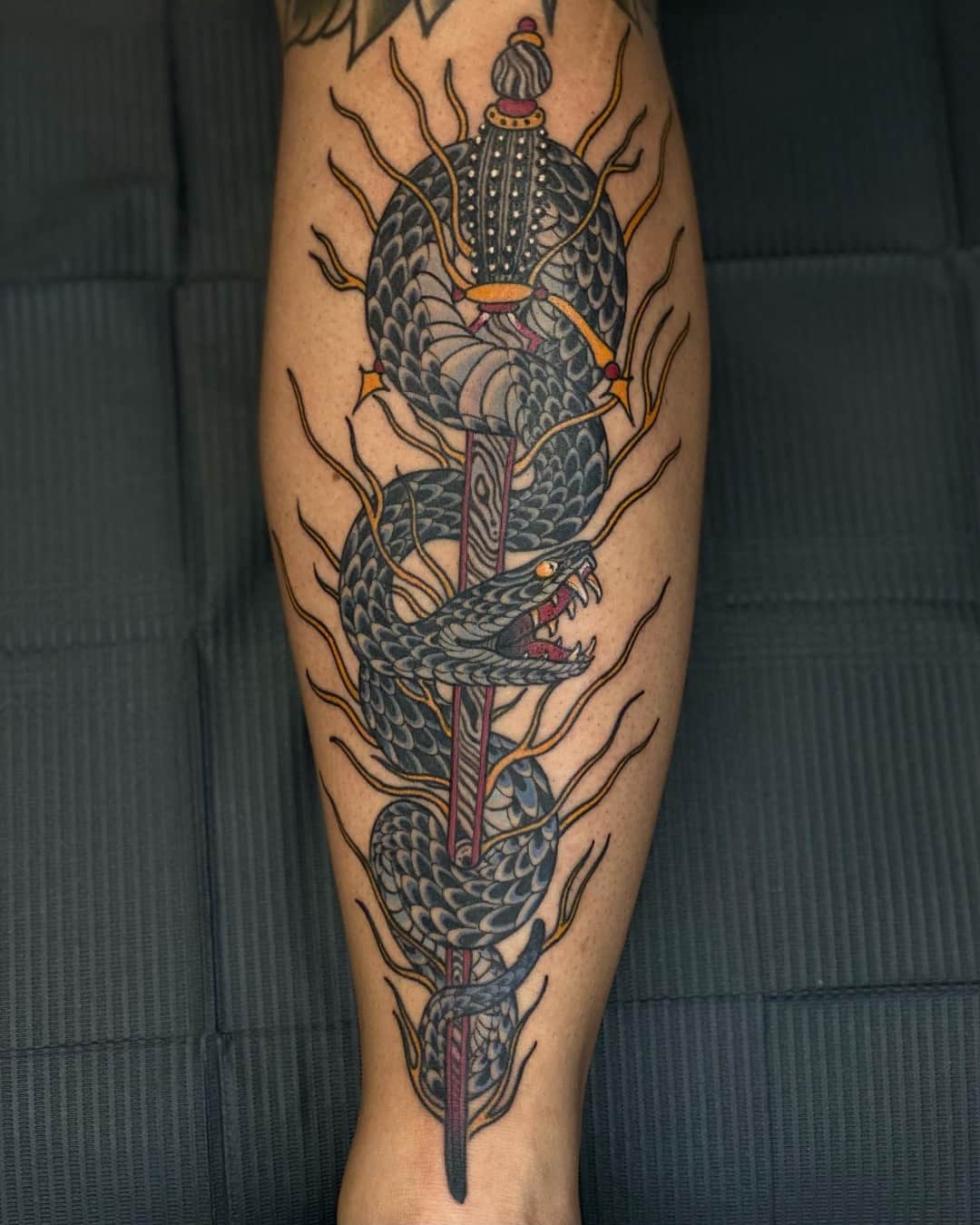 Dragon, sword and fire tattoo on the calf, large piece, Illustrative style, by Donny Newman in Austin, TX