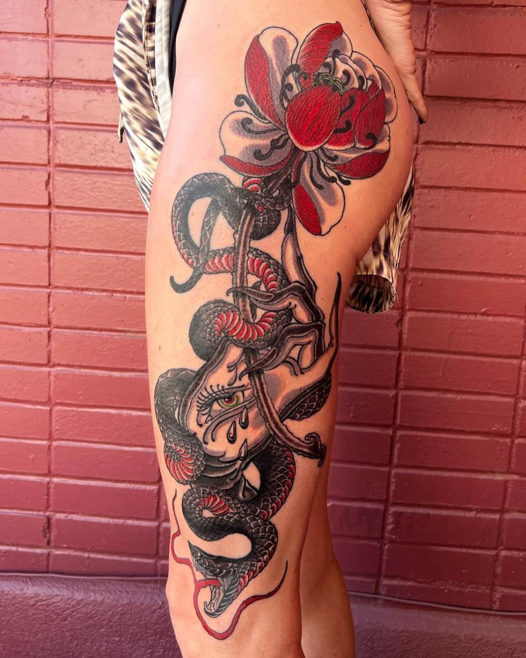 Snake, flower and ornamental filigree tattoo on the thigh, large piece, Illustrative style, by Donny Newman in Austin, TX