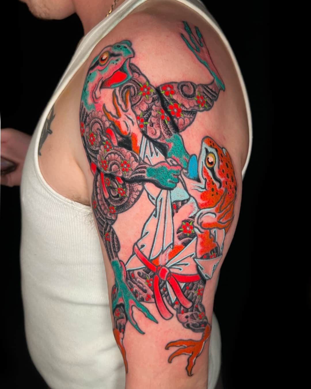 Frog, flower and ornamental filigree tattoo on the upper arm, large piece, Illustrative style, by Donny Newman in Austin, TX