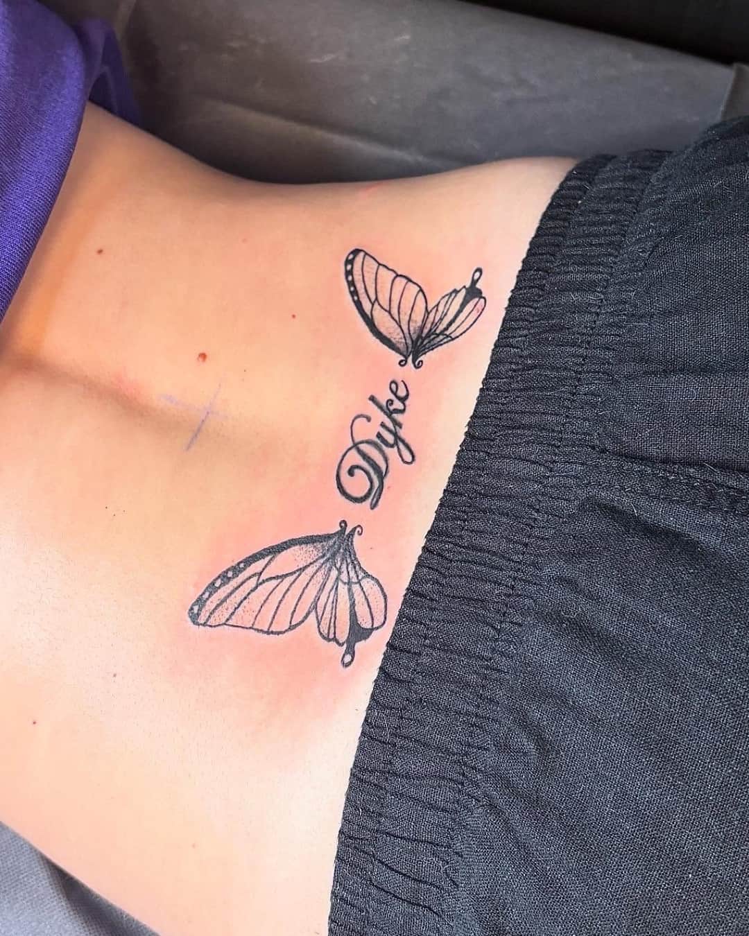 Butterfly tattoo on the lower back, Lettering style, by Emma in Austin, TX