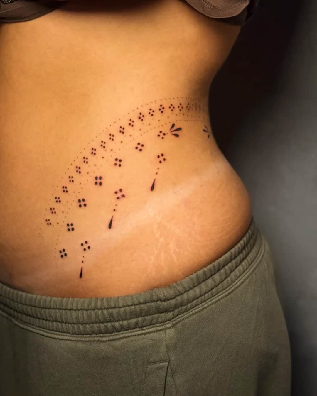 Small ink splash and abstract tattoo on the ribs, Ornamental style, by Luisa Duarte in Austin, TX