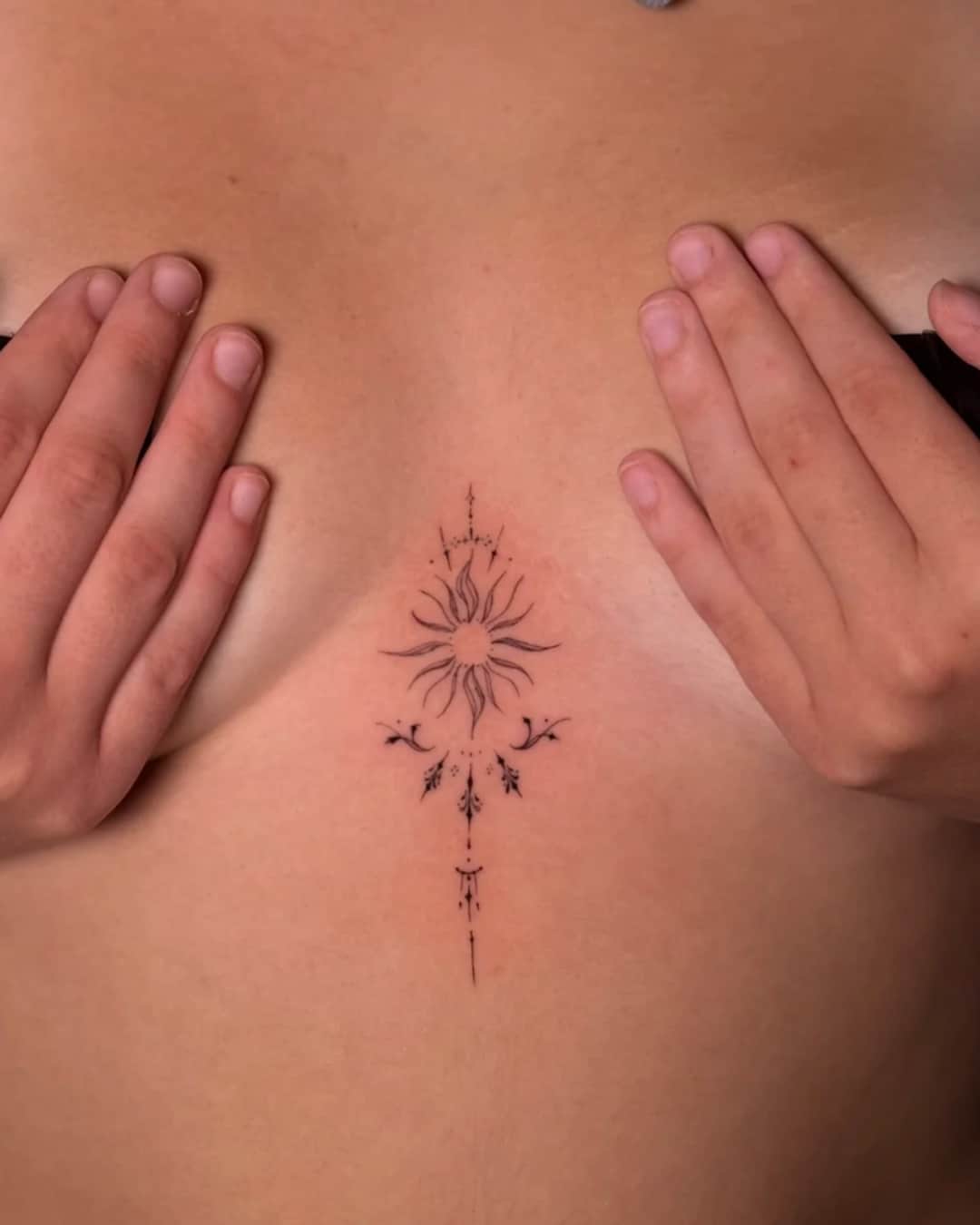 Small sun, moon and geometric pattern tattoo on the sternum, Ornamental style, by Luisa Duarte in Austin, TX