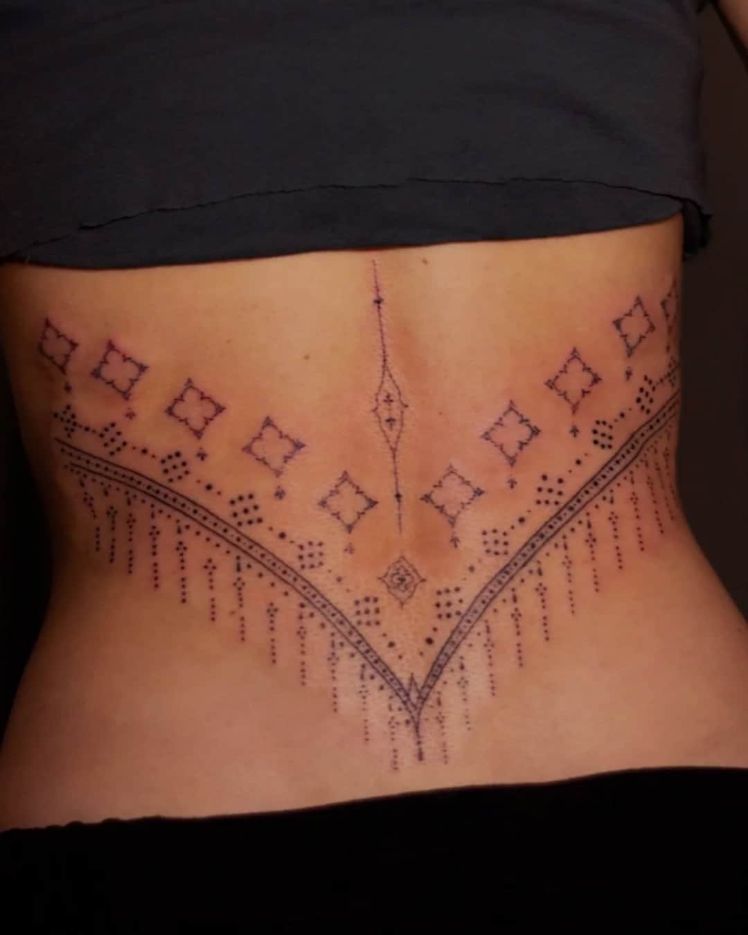 Ornamental filigree and geometric pattern tattoo on the lower back, large piece, Ornamental style, by Luisa Duarte in Austin, TX