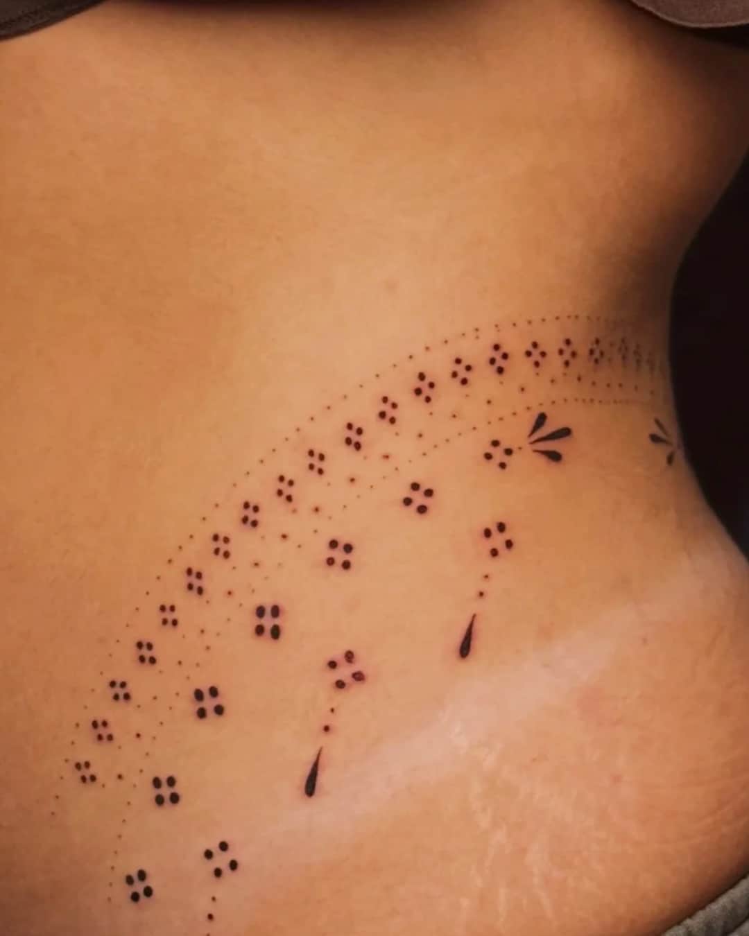 Small lettering tattoo on the ribs, Ornamental style, by Luisa Duarte in Austin, TX