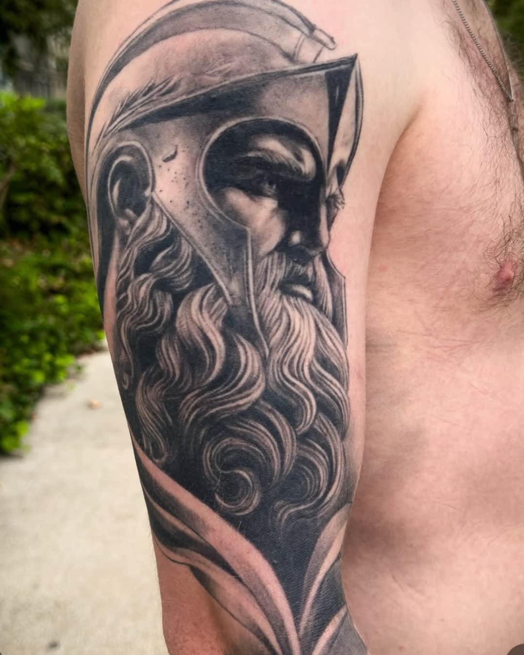 Warrior and portrait tattoo on the upper arm, half sleeve, Realism style, by Raphael giaimo in Lyon, France