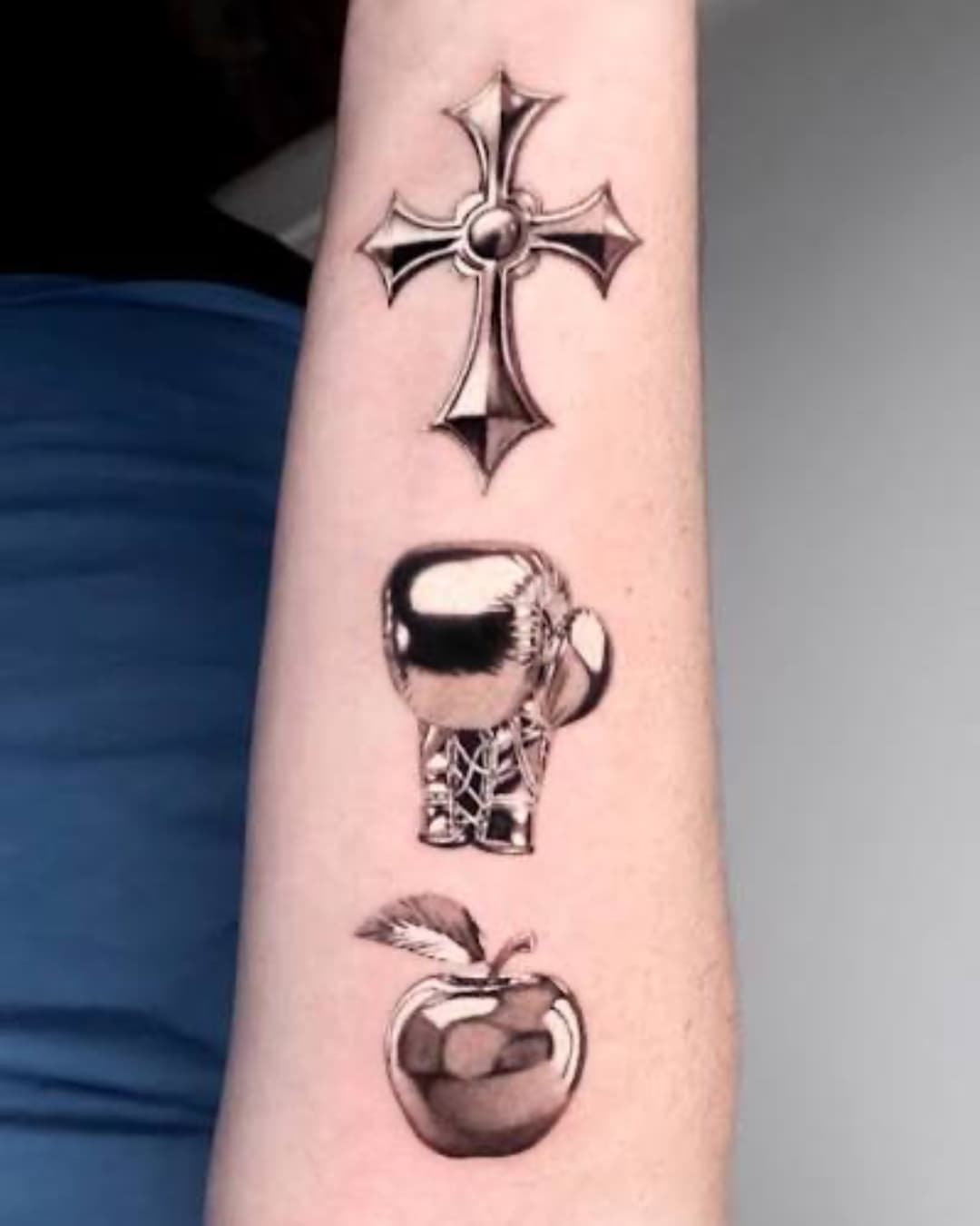 Cross, fruit and astronaut tattoo on the forearm, patchwork, Chrome style, by test in Lyon, France