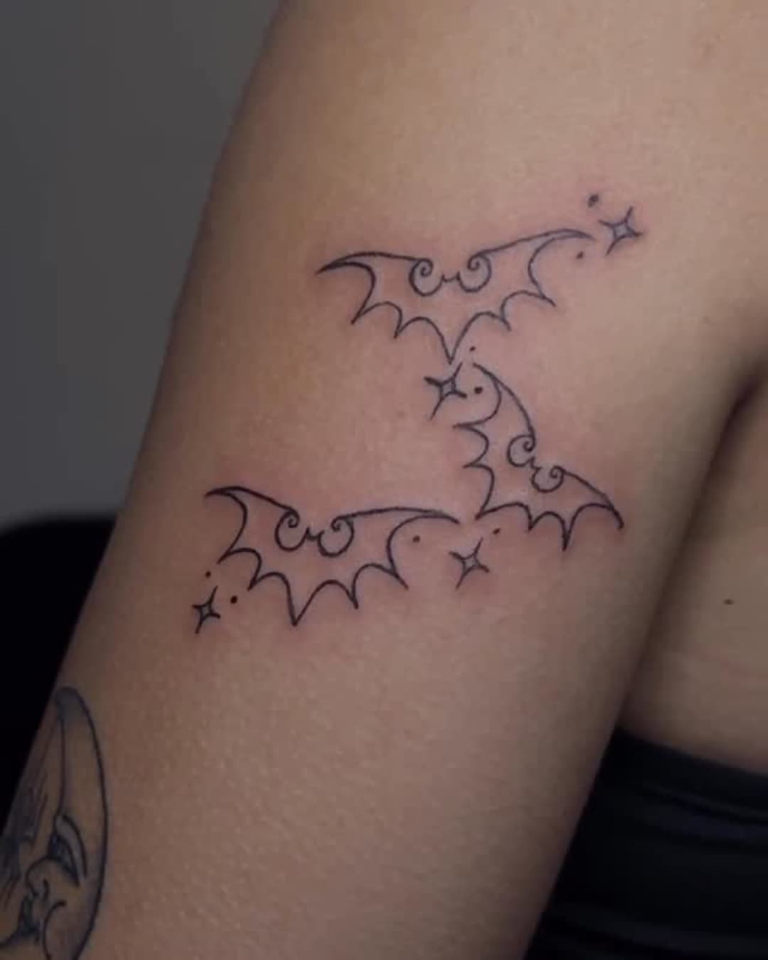 Bat and star tattoo on the upper arm, Cyber-tribal style, by Emma in Austin, TX