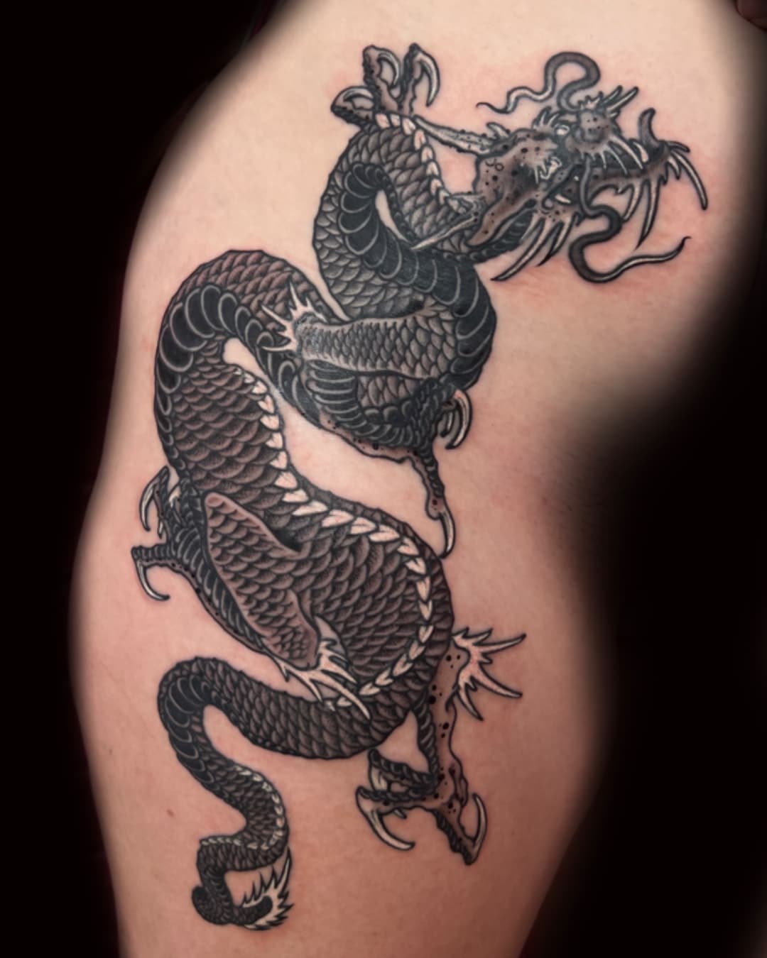 Dragon tattoo on the thigh, large piece, Illustrative style, by Donny Newman in Austin, TX