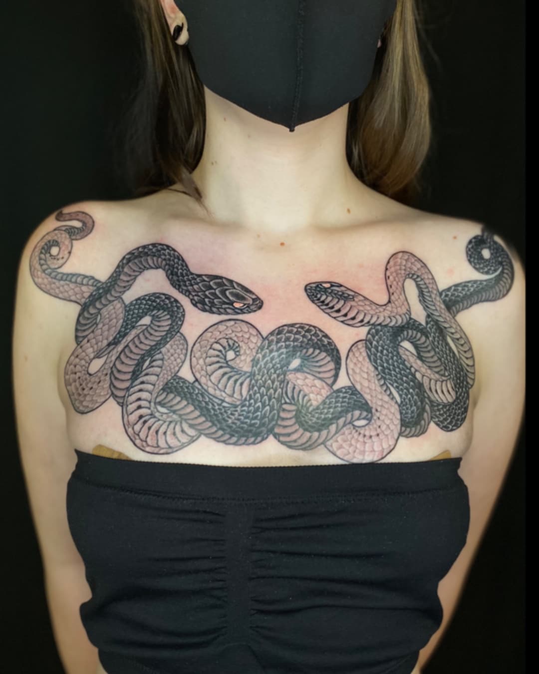 Snake tattoo on the chest, large piece, Illustrative style, by Donny Newman in Austin, TX