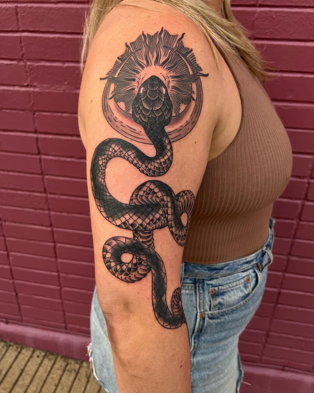Snake and sun tattoo on the upper arm, large piece, Illustrative style, by Donny Newman in Austin, TX