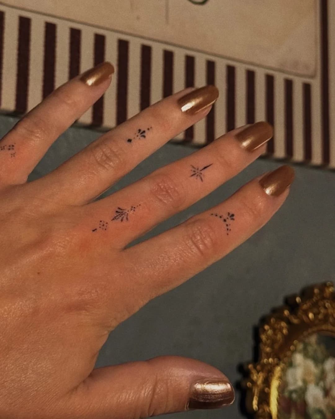 Small star tattoo on the fingers, Ornamental style, by Luisa Duarte in Austin, TX