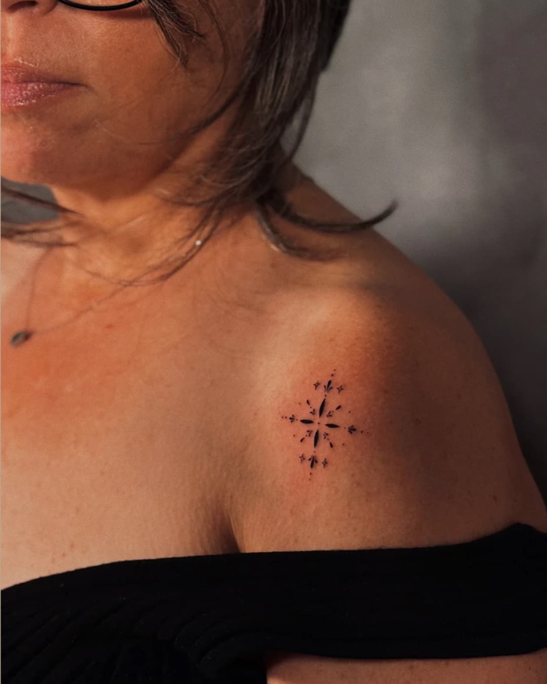Small star and geometric pattern tattoo on the shoulder, Ornamental style, by Luisa Duarte in Austin, TX