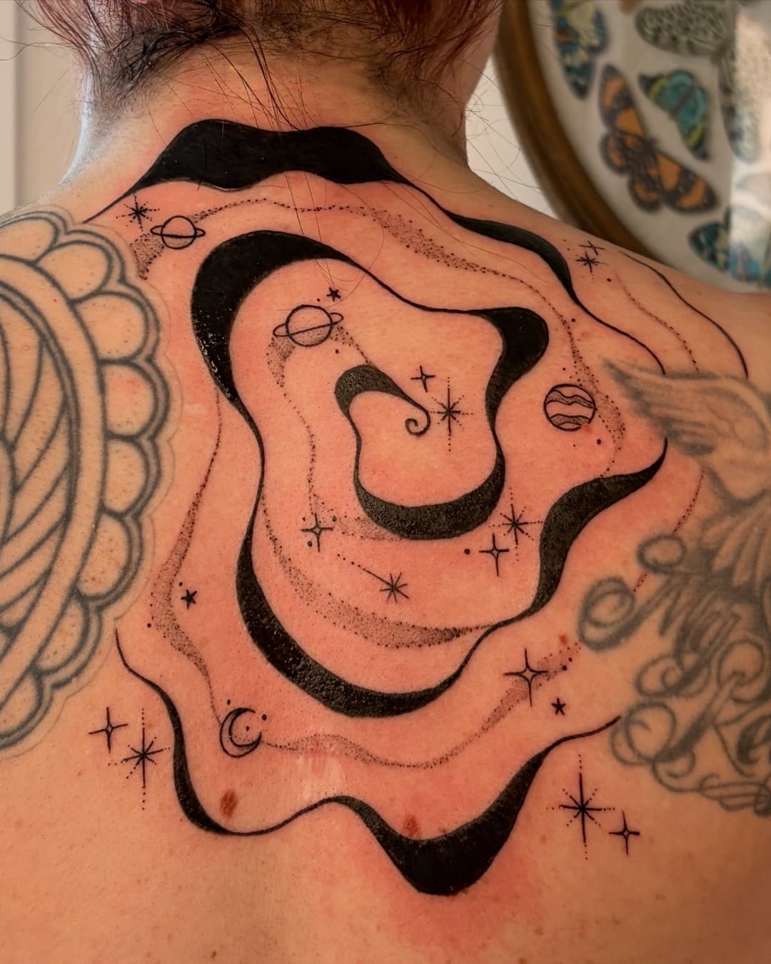 Star, planet and moon tattoo on the upper back, Suminagashi style, by Emma in Austin, TX